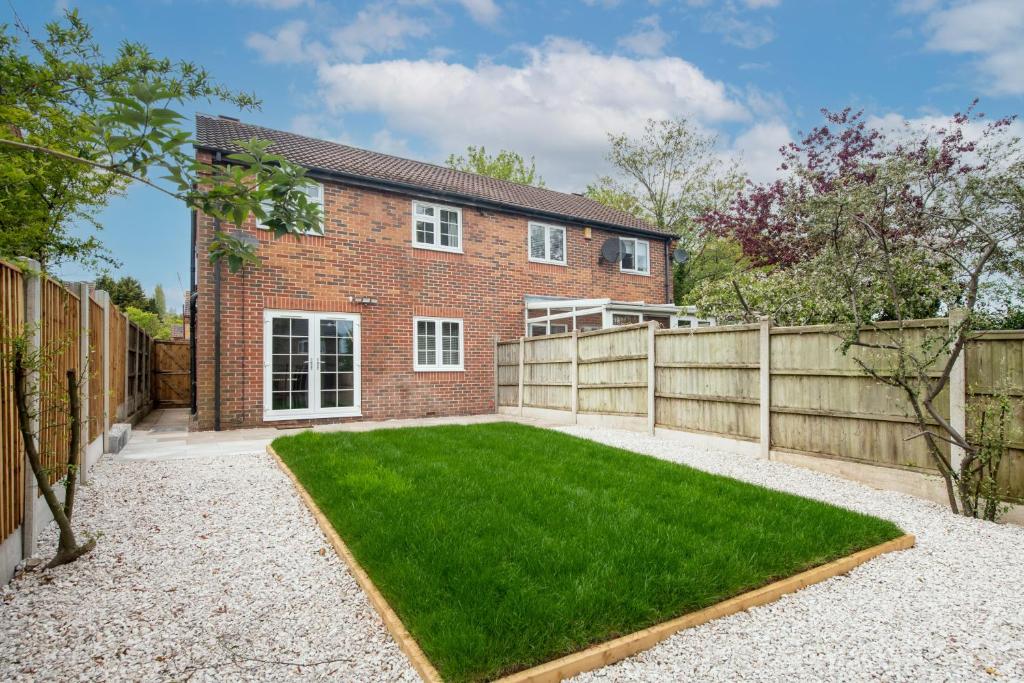 a brick house with a fence and a yard at 4 Bedroom Family & Contractor House in Colwick, Nottingham - Sleeps 8 - By CircleWay Homes in Nottingham
