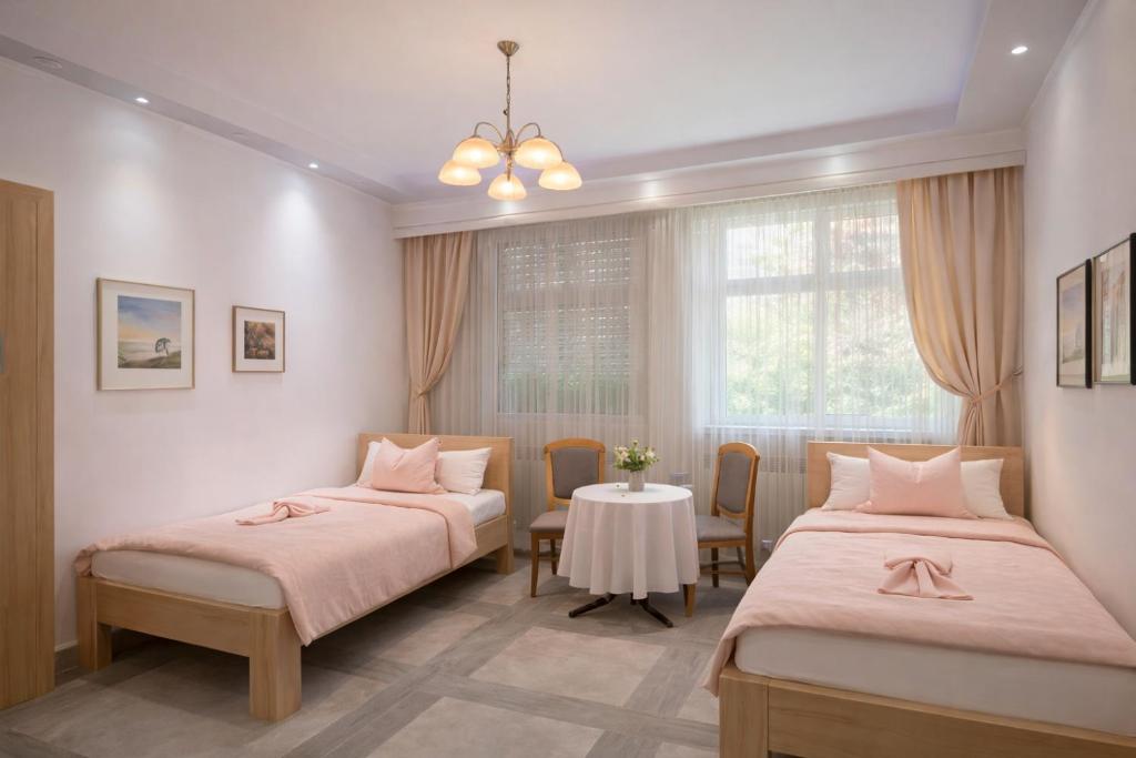 two beds in a room with a table and chairs at Gelsenkirchen Am Flöz in Gelsenkirchen