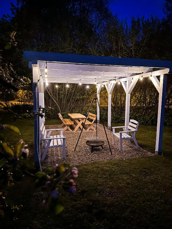 a playground with a swing and a pavilion at night at Gasthaus Radków in Radków