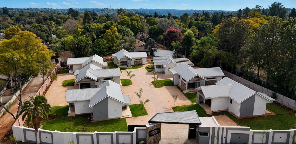 an aerial view of a row of white houses at 19 On Bay Noakes in Harare
