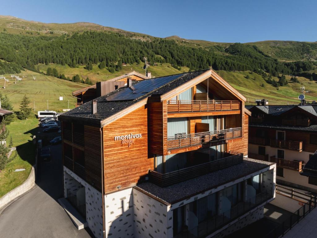 an overhead view of a house with a mountain in the background at Montivas Lodge in Livigno