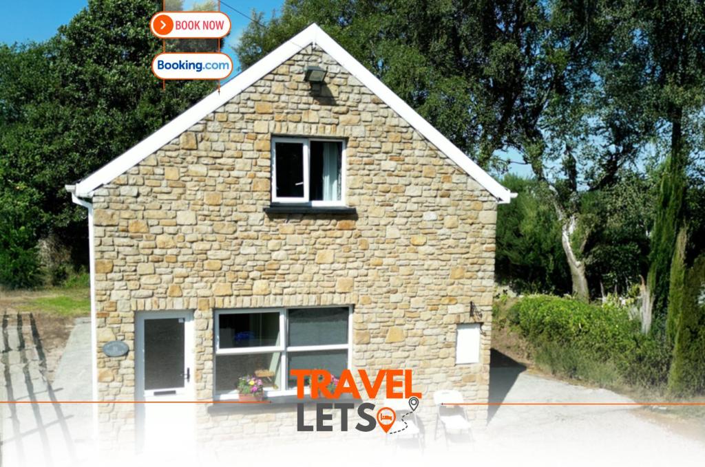 a small stone house with a window on a street at Heartbeat Cottage By Travel Lets Holiday Homes Letterkenny With Private Ensuite Rooms & Garden in Letterkenny