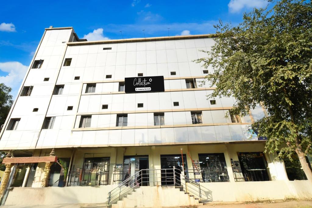a white building with a sign on it at Super Collection O Godavari Kompally in Hyderabad