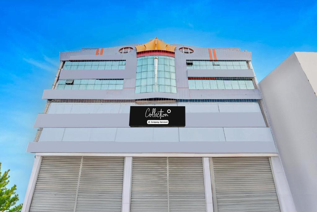 a tall white building with a sign on it at OYO Collection O NAD Near Airport in Visakhapatnam