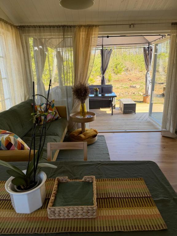 a living room with a green couch and a table at Holiday home Kolmårdsgården in Kolmården