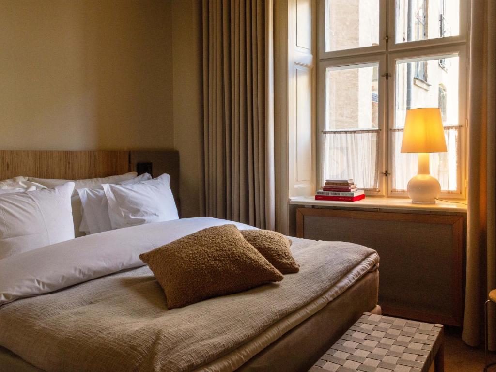 a bedroom with a bed and a window at Four Suites Copenhagen - Boutique Townhouse Suites in Copenhagen