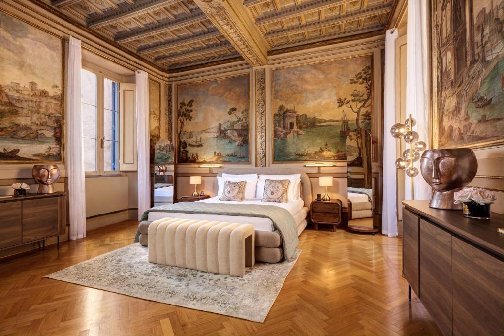 a bedroom with a bed and paintings on the walls at Palazzo Massimo Boutique Piazza Venezia in Rome