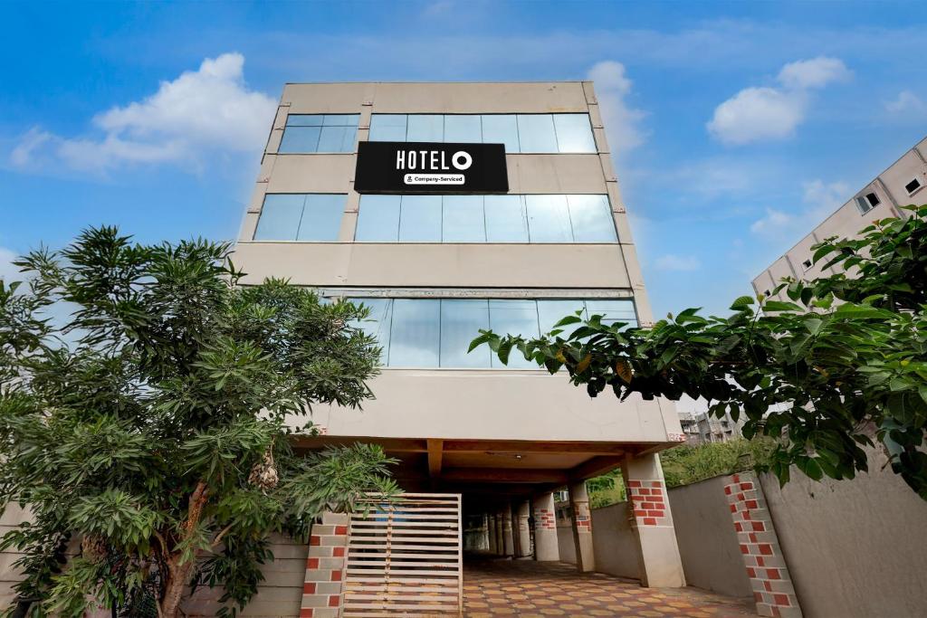 a hotel with a sign on the side of a building at OYO Hotel O Benz Circle Vijayawada in Vijayawāda