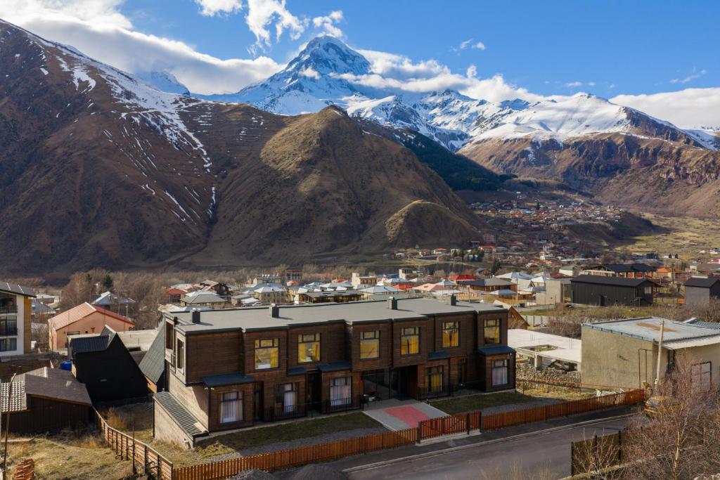 ein großes Gebäude vor einem Berg in der Unterkunft Melodia KAZBEGI in Kazbegi