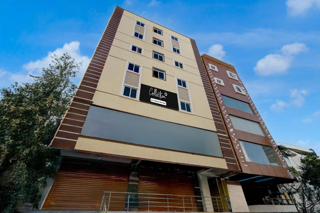 a tall building with a sign on it at Super Collection O Forum Mall Hyderabad Formerly Ruby Grand Inn in Kondapur