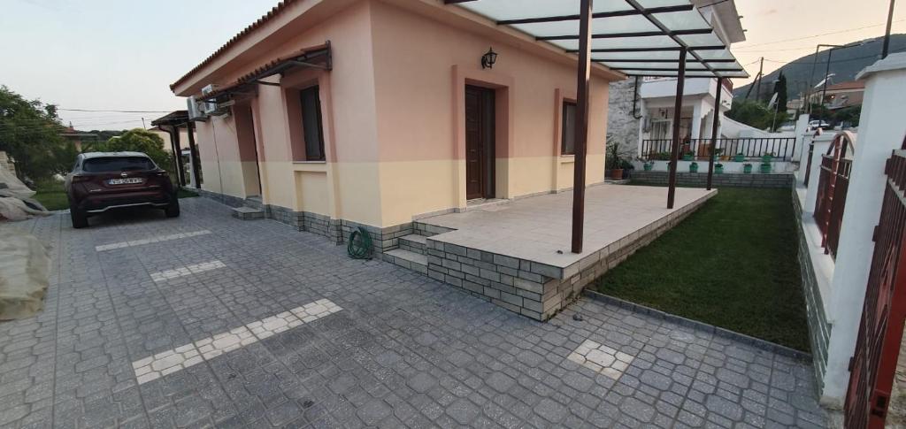 a house with a car parked in front of it at Sofia villa in Elaiokhórion