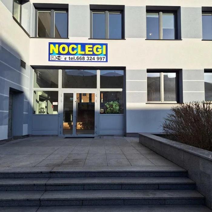 a building with a sign on the front of it at Hostel Włocławek in Włocławek