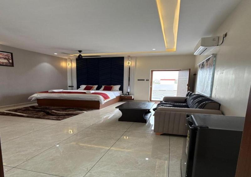 a living room with a bed and a couch at SNR GRAND in Narasaraopet