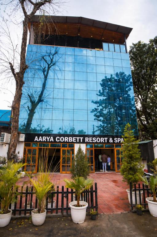 a building with a sign that readsanya confluent resort and spa at AARYA Corbett Resort & SPA - 8 minutes drive to Kosi River in Nainital