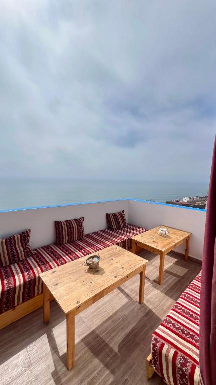 a living room with two tables and a couch at Appartement Tourma in Agadir