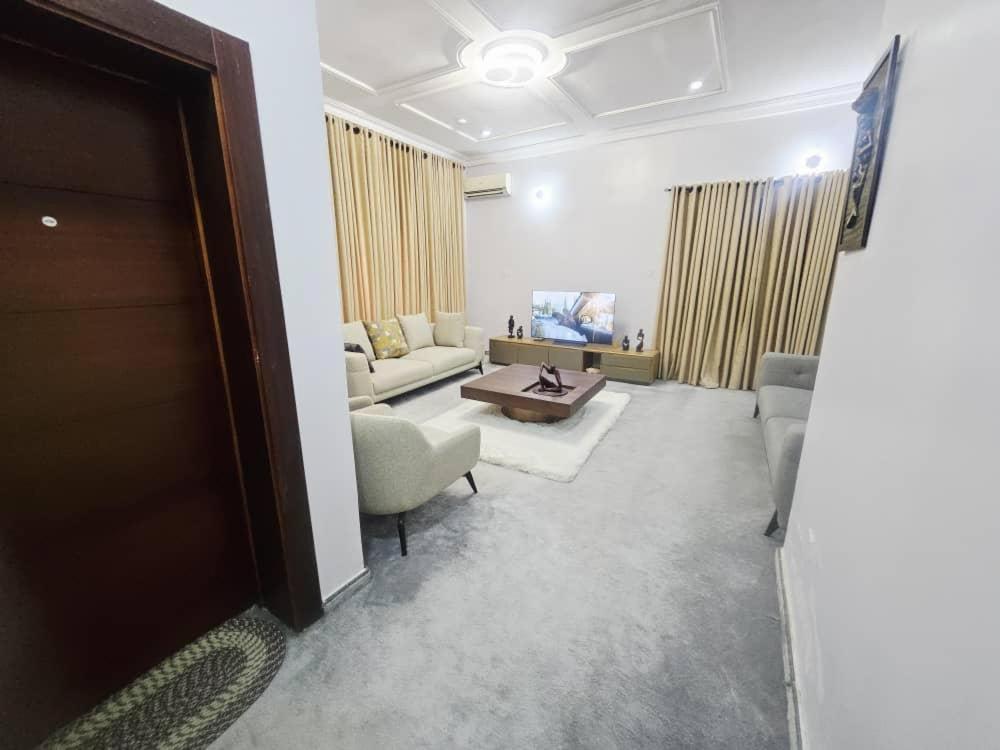 a living room with a couch and a table at The Nest in Aso