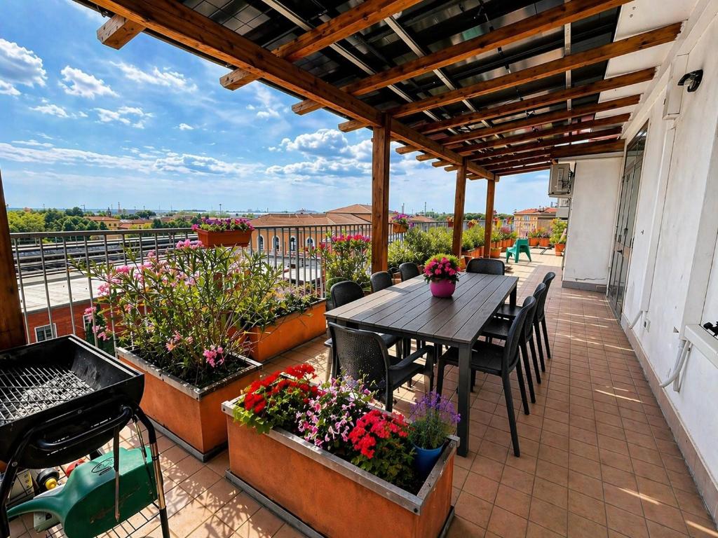 a patio with a table and flowers on a balcony at B&B Colombo in Pisa