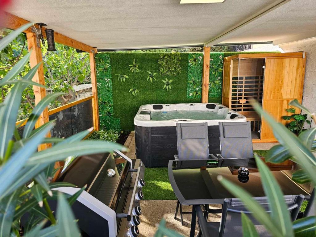 an outdoor hot tub in a backyard with plants at Adriatic SPA Apartment in Selce