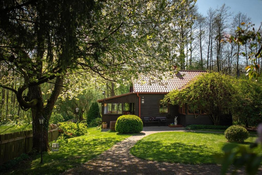 a house with a garden and a fence at Zacisze nad Sanną in Annopol