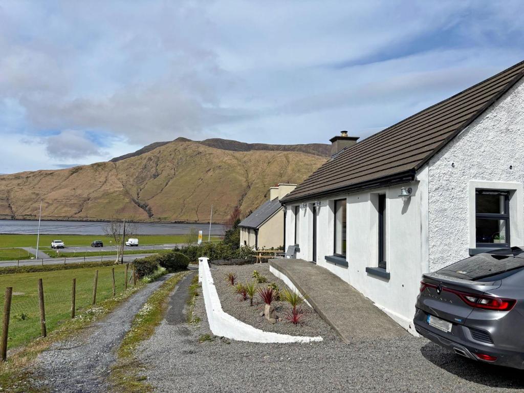 a house with a car parked outside of it at Cottage 503 - Leenane in Leenaun