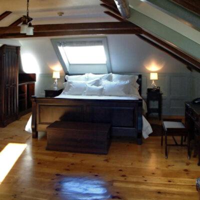 a bedroom with a large bed with a window at Mariner King Inn in Lunenburg