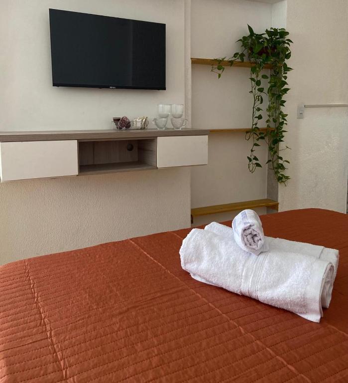 a hotel room with a bed with a towel at Casa Freitas - Suíte 2 in Extrema