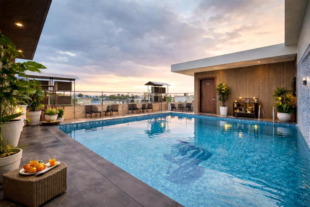 a swimming pool with a view of a hotel at Hotel Wilkisto By Amar Singh Near Taj Mahal in Agra