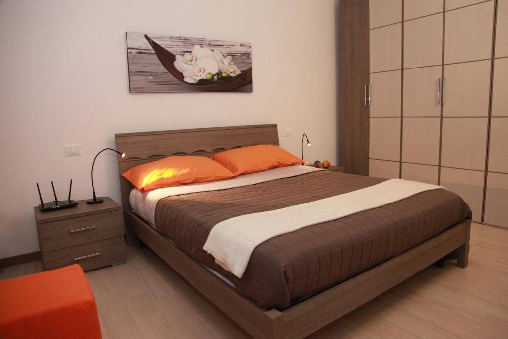 a bedroom with a bed with orange pillows at Home Sweet Home in Lavagna