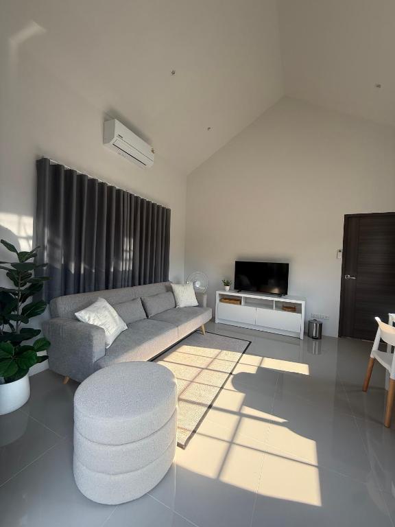a living room with a couch and a table at Tiny Home - Hin Lad Waterfall in Nathon Bay