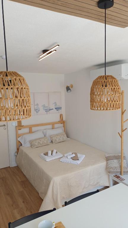 a bedroom with a bed with two towels on it at Seabird Lisbon Studio in Charneca