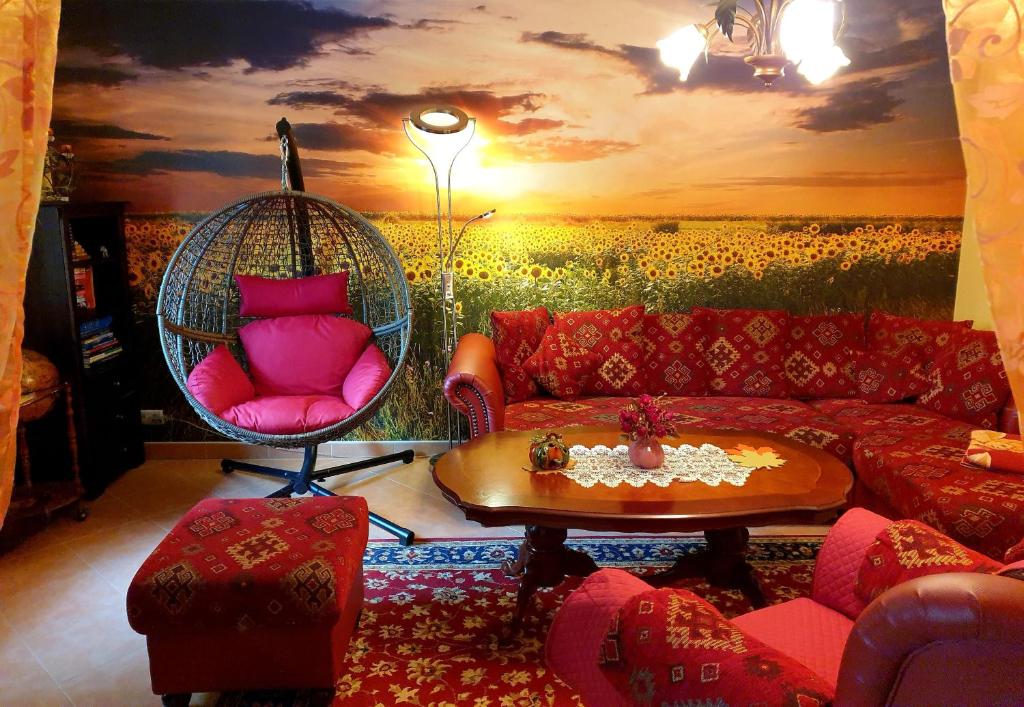 a living room with a swing and a sunset at Ferienhäuser Harmonie I & II in Burg Kauper