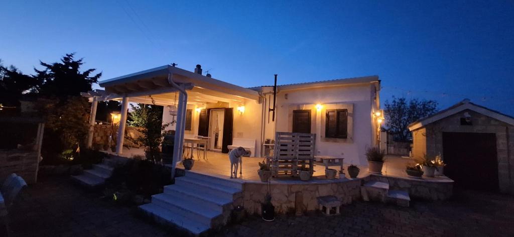 a man standing in front of a house at night at Bed & Breakfast Oasi San Giovanni in Altamura