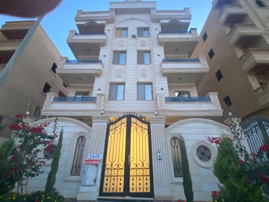 a building with a yellow gate in front of it at Spacious Apartment In 6 October in 6th Of October