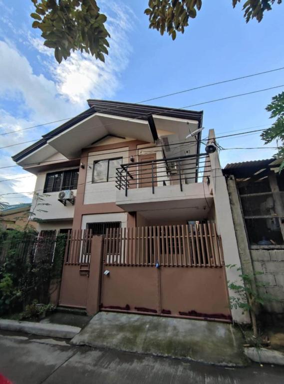 a house with a fence in front of it at GLJ Apartment in Ormoc