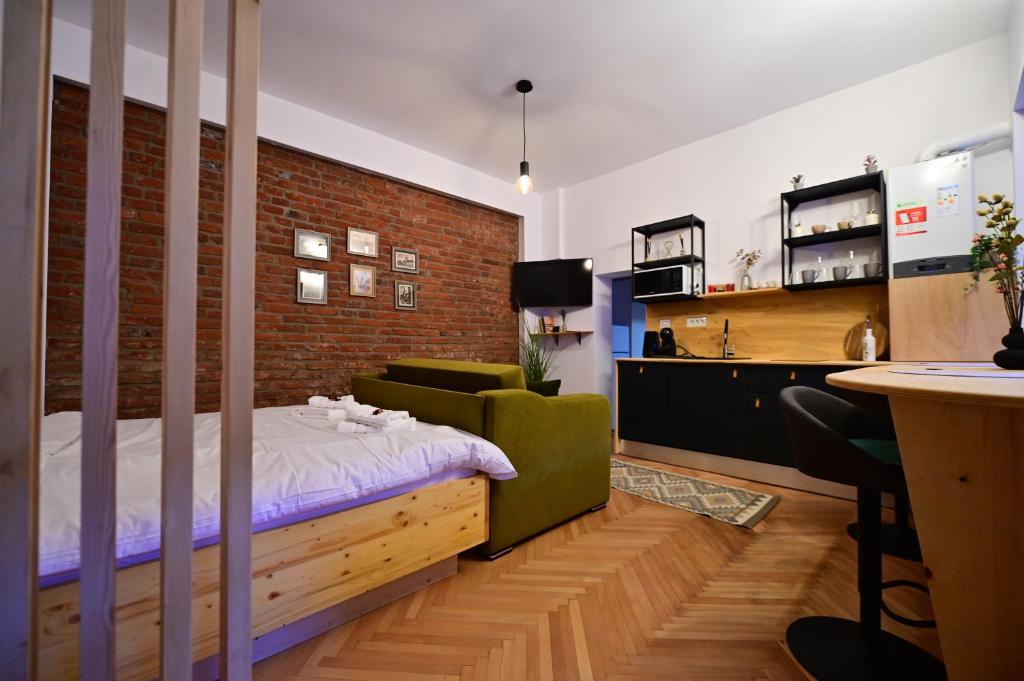 a bedroom with a bed and a brick wall at FLH - Hömvert in Sibiu