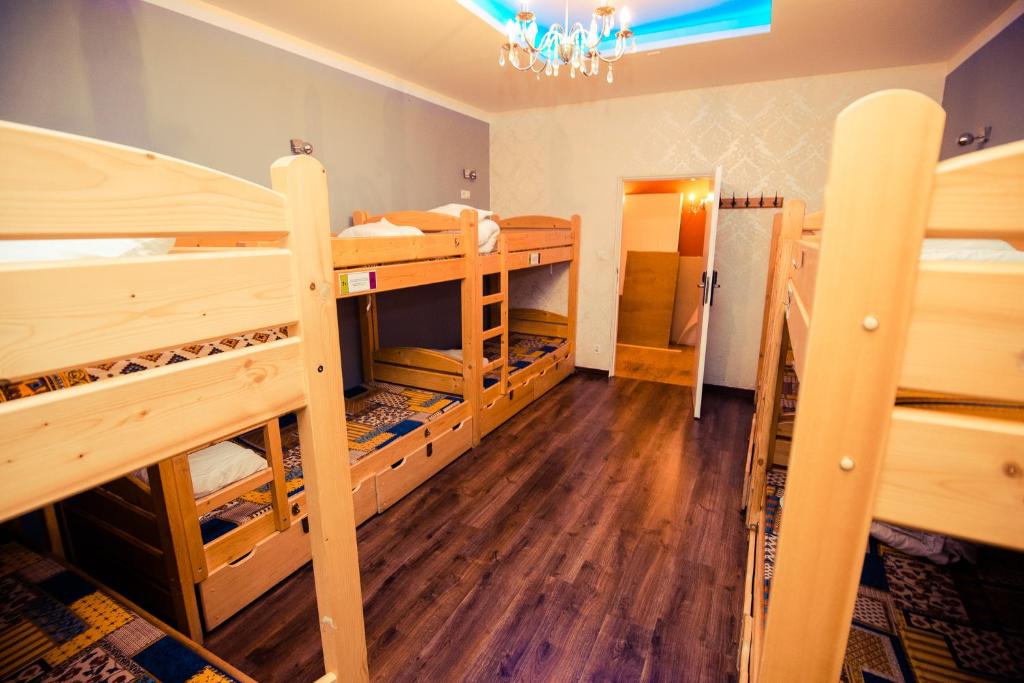 a room with two bunk beds and a hallway at Greg&Tom Beer House Hostel in Krakow