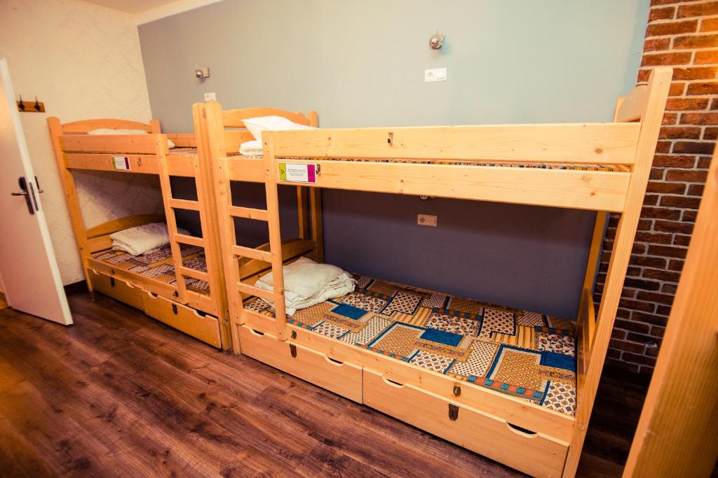 a room with two bunk beds in a room at Greg&Tom Beer House Hostel in Krakow