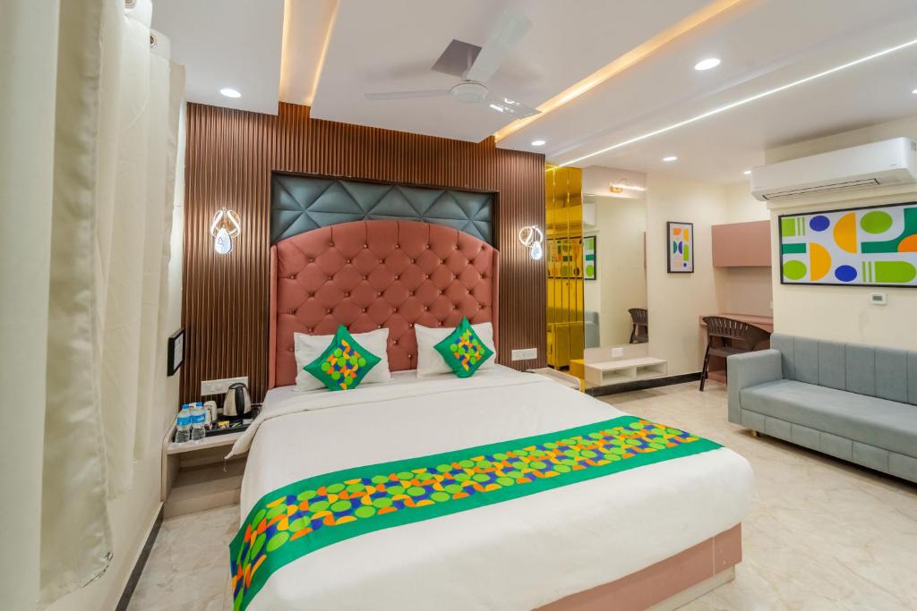 a bedroom with a large bed and a couch at Treebo Vistara Gold Ujjain Junction in Ujjain