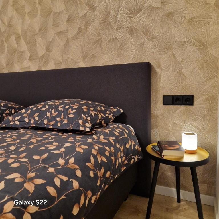 a bedroom with a bed and a side table at 't Westeind, Modern en sfeervol appartement in Norg in Norg