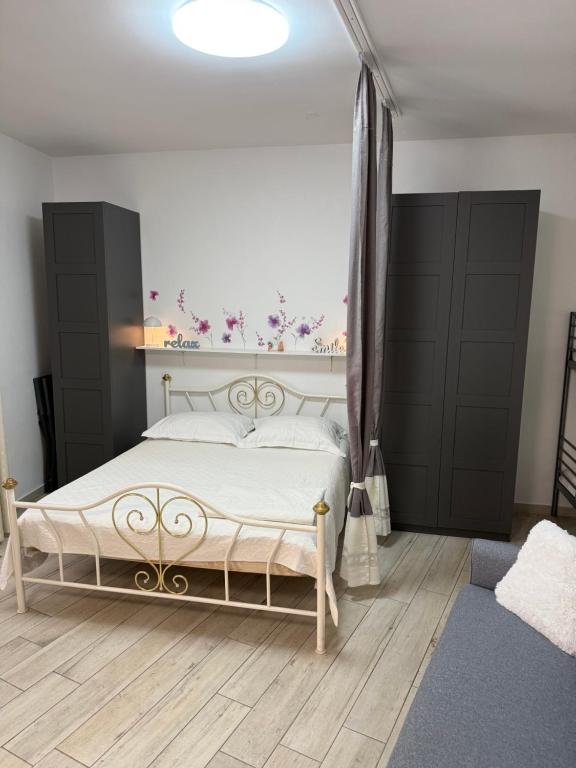 a bedroom with a white bed with a flower wall at San Nicolò in Umag