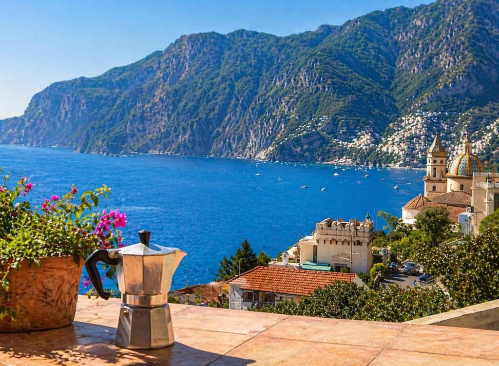 a view of a body of water with a church and a castle at La dimora degli Dei in Praiano