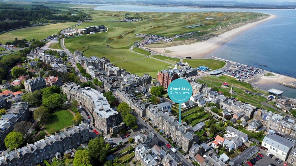 an aerial view of a city with a beach at Playfair Terrace 6a in St. Andrews