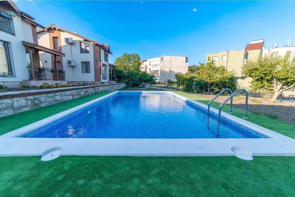a swimming pool in the middle of a yard at Smokinite Villa 1 - Pool and BBQ near the beach in Varna City