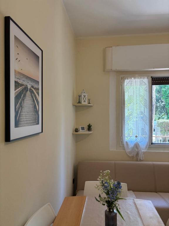 a dining room with a table and a window at Mare & Pineta in Punta Marina