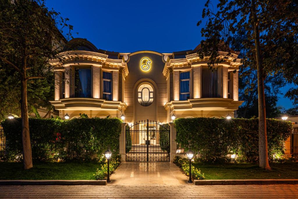 a house with a gate in front of it at night at Sam's Story Boutique Hotel in Cairo