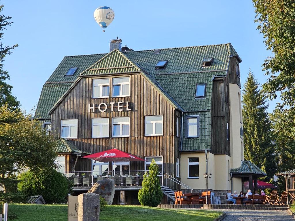 a hotel with a sign on the front of it at waldhotel AUSZEIT mit Restaurant & Café in Tanne