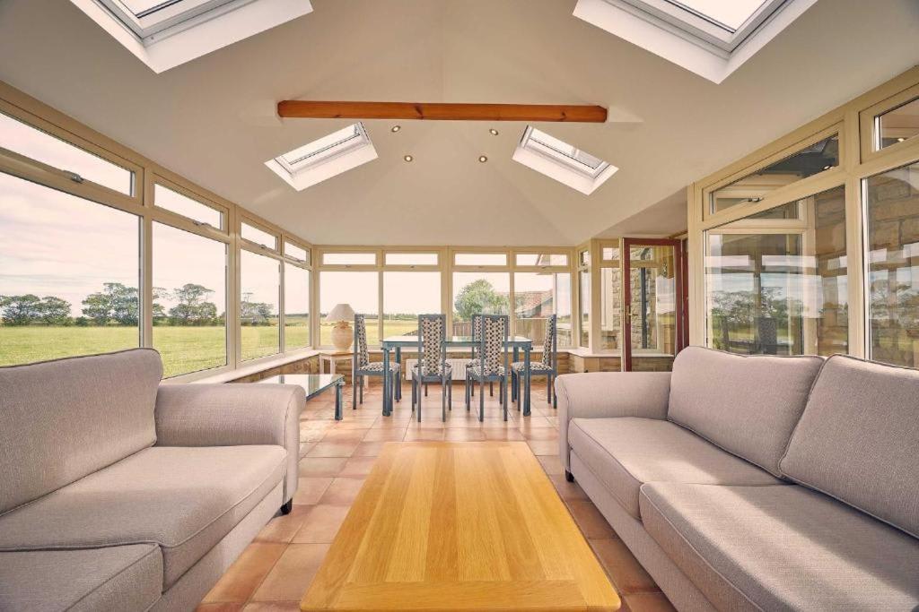 a living room with two couches and a table at Host & Stay - Cheviot View in Seahouses