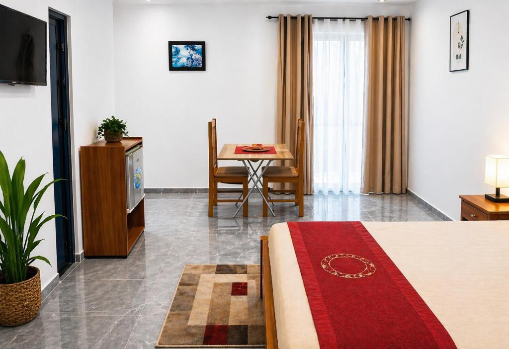 a hotel room with a bed and a table at Praia City Apartments in Praia