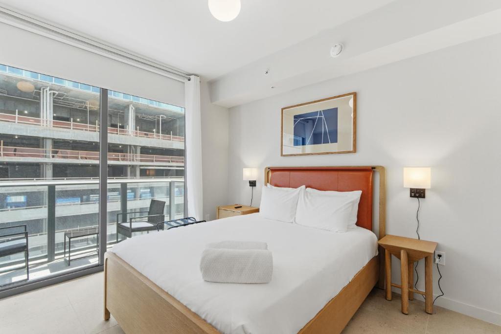 a bedroom with a bed and a large window at Downtown Studio Steps from Kaseya Center in Miami
