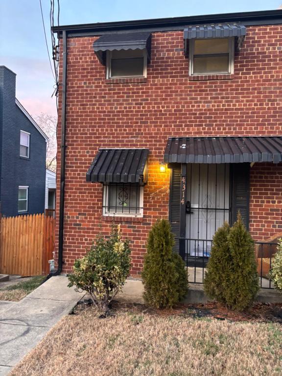 a brick house with a black awning at Peace & Relax sensation in Washington, D.C.